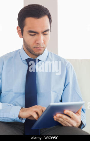 Young classy businessman using tablet pc Stock Photo