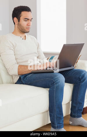 Focused handsome man using his tablet computer Stock Photo
