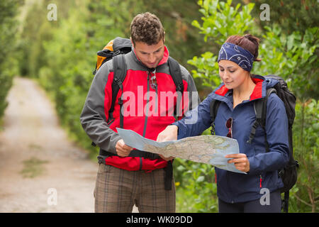 Happy couple going on hike together looking at map Stock Photo