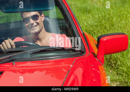 Smiling handsome man driving his cabriolet Stock Photo