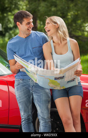 Smiling young couple reading map Stock Photo