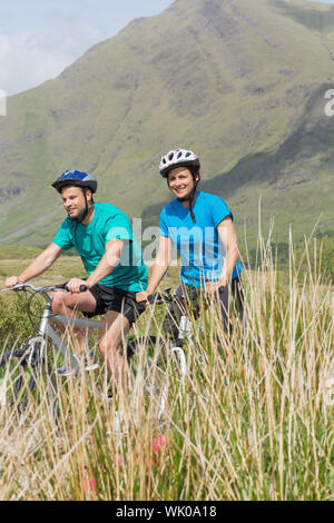 Fit couple cycling together Stock Photo