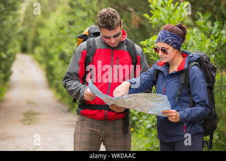 Couple going on a hike together looking at map Stock Photo