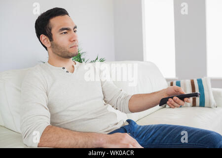 Serious man holding remote control Stock Photo