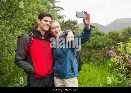 Happy couple on hike taking a selfie Stock Photo
