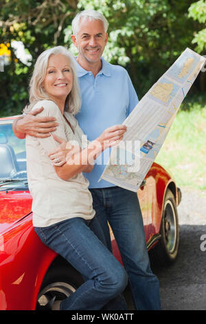 Happy mature couple reading map together Stock Photo