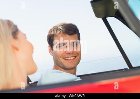 Smiling man looking at his pretty girlfriend while driving Stock Photo
