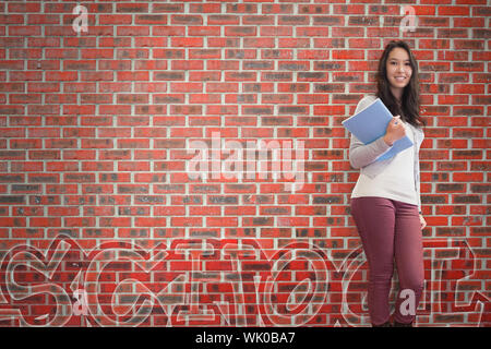 Smiling student holding notebook posing Stock Photo