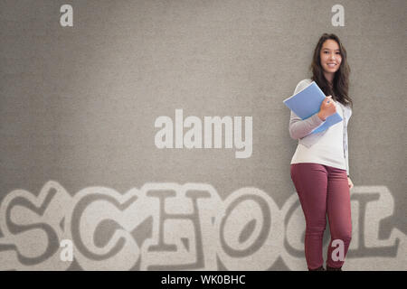 Cheerful student holding notebook posing Stock Photo