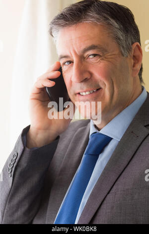 Smiling man calling someone with his mobile phone Stock Photo