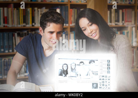Happy college friends watching photos on digital interface Stock Photo