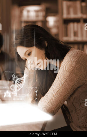Student using futuristic hologram to learn biology from tablet Stock Photo