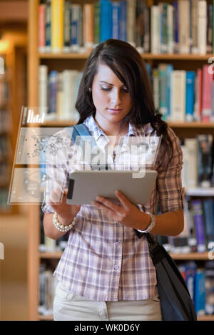 Pretty student working on her digital tablet computer Stock Photo