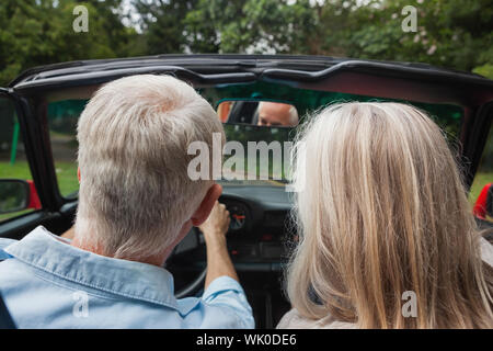 Rear view of mature couple going for a ride together Stock Photo