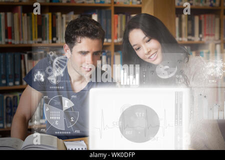 Smiling college friends studying on digital interface Stock Photo