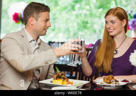 Cheerful couple having dinner together Stock Photo