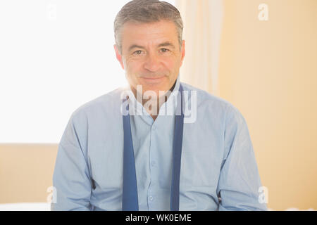 Content man looking at camera sitting on a bed Stock Photo