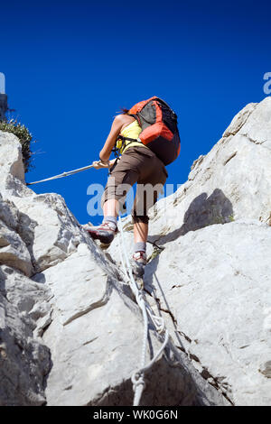 young woman reaching the top of a mountain. Copy space Stock Photo