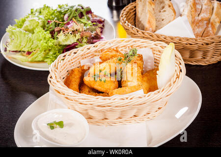 Crumbed chicken nuggets in a basket Stock Photo