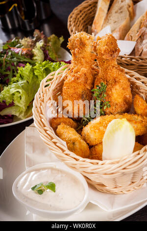 Crisp crunchy golden chicken legs and wings Stock Photo