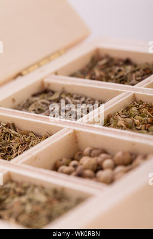 Overhead view of a tray with individual divisions displaying assorted dried spices and herbs for use in a kitchen to season and flavour food when cook Stock Photo