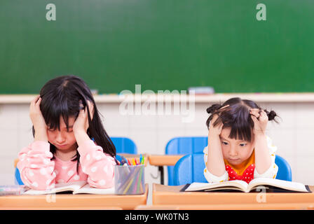two sad girls doing in homework Stock Photo