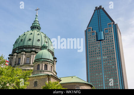 Montreal, Canada - 03 September 2019: La Gauchetiere building & Mary, Queen of the World Cathedral Stock Photo