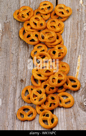 Heap of Crunchy Pretzels In a Row closeup on Rustic Wooden background Stock Photo