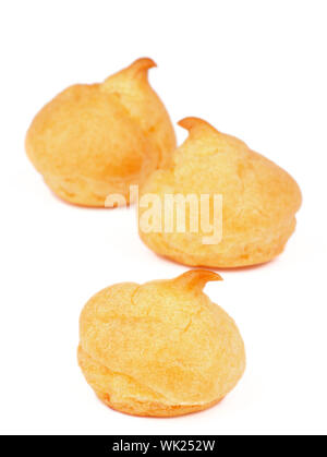 Three Freshly Baked Profiteroles isolated on white background Stock Photo