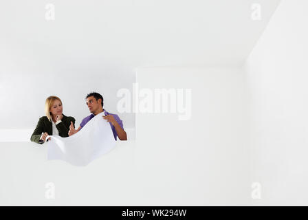 low angle view of male architect and woman examining blueprints. Copy space Stock Photo