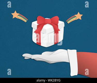 Merry Christmas and happy new year with gift box or present over Santa Claus hand on blue background in paper cut style. Vector illustration design fo Stock Vector
