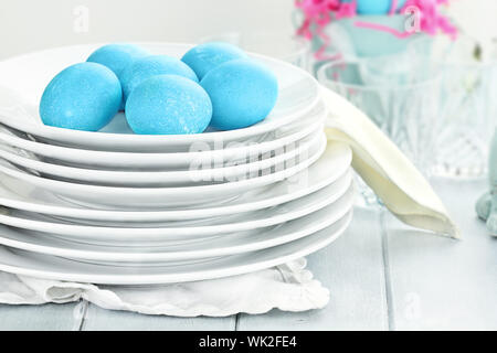 Blue dyed eggs with plates for Easte. Shallow depth of field. Stock Photo