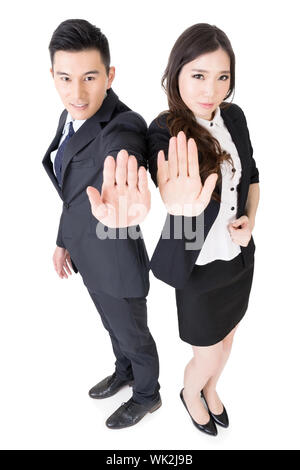 Business man and woman give you a gesture of stop, full length portrait isolated on white background. Stock Photo