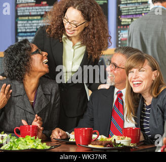 Diverse group of four happy executives having lunch Stock Photo