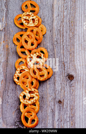 Crunchy Tasty Pretzels In a Row isolated on Rustic Wooden background Stock Photo