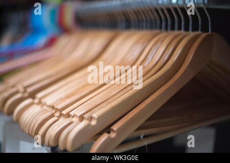 clothes hangers in the store are in a row. Stock Photo
