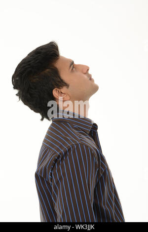 Side profile of an Indian young man looking up Stock Photo