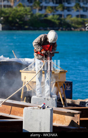 Man working with jackhammer in a harbor Stock Photo