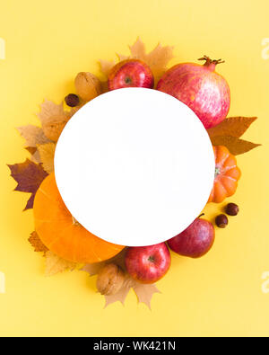 Yellow autumnal leaves, fruits and vegetables flat lay, copy space. Creative seasonal autumn layout, thanksgiving, rosh hashanah holiday concept. Stock Photo