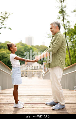 Mature man meeting his adopted girl in the park Stock Photo