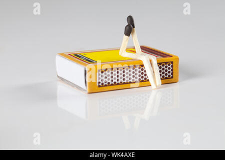 Two matchsticks represent love or friendship on a matchbox Stock Photo