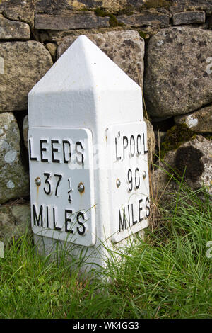 A milepost on the Leeds Liverpool canal near East Marton, Yorkshire, UK. Stock Photo