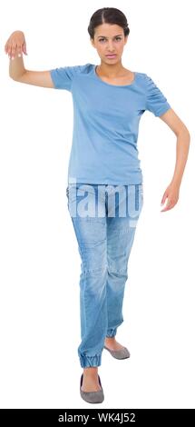 Powerless brunette in jeans and tshirt on white background Stock Photo