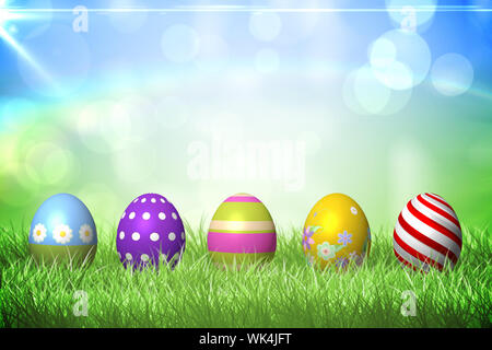 Colourful easter eggs on the grass under sunny sky Stock Photo