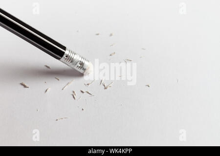 Studio shot of pencil erasing from piece of paper Stock Photo