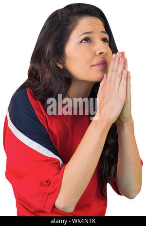 Nervous football fan in red on white background Stock Photo