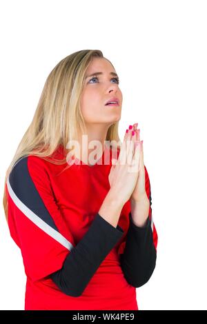 Nervous football fan in red on white background Stock Photo