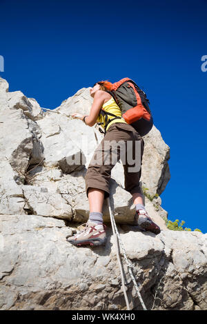young woman reaching the top of a mountain. Copy space Stock Photo