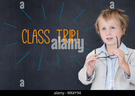 The word class trip! against schoolboy and blackboard Stock Photo