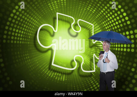 Composite image of jigsaw piece and businessman holding umbrella against green pixel spiral Stock Photo